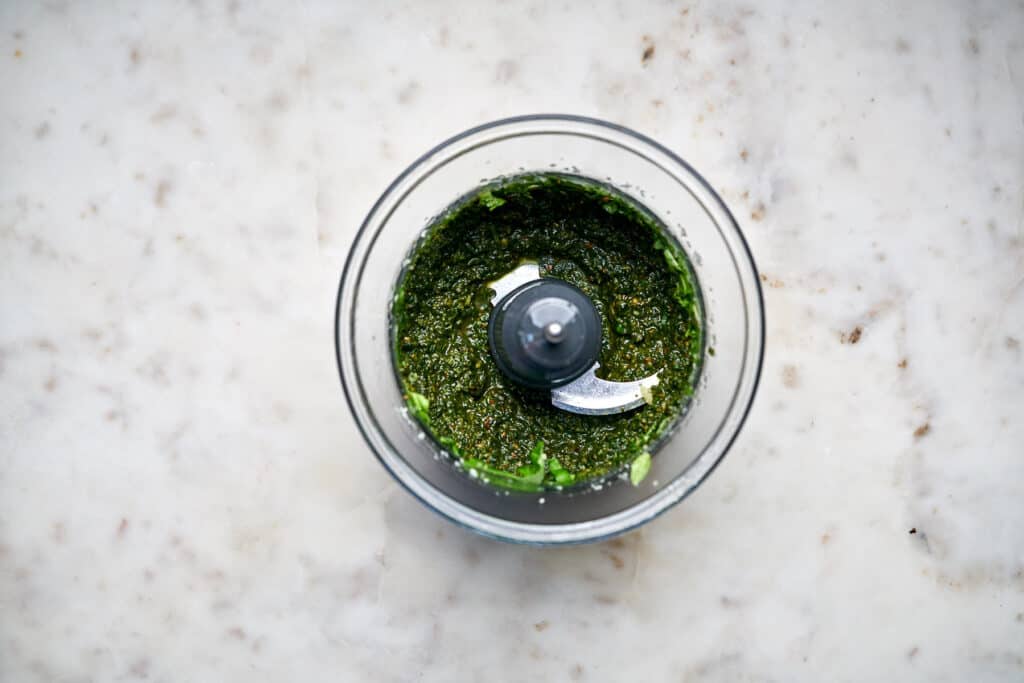 Food processor with green pesto.