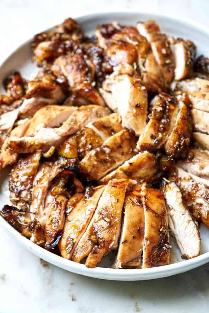 Sliced chicken on a white plate.