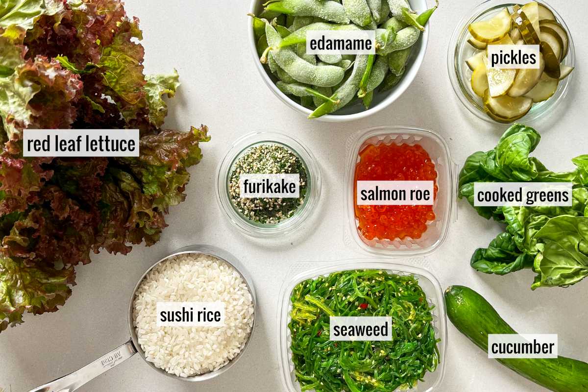 Lettuce, greens, sushi rice, and other veggies on a countertop.