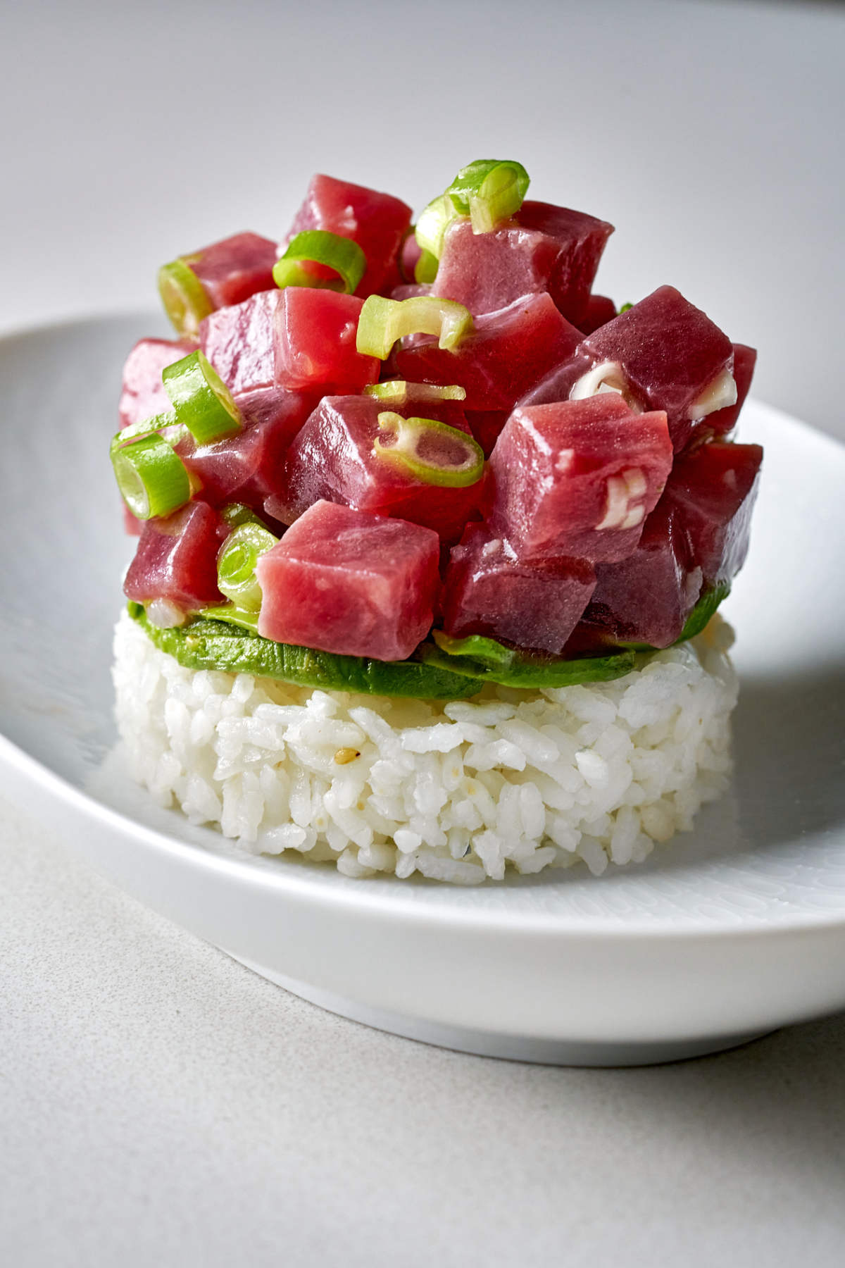 Tuna tartare on top of avocado and rice.