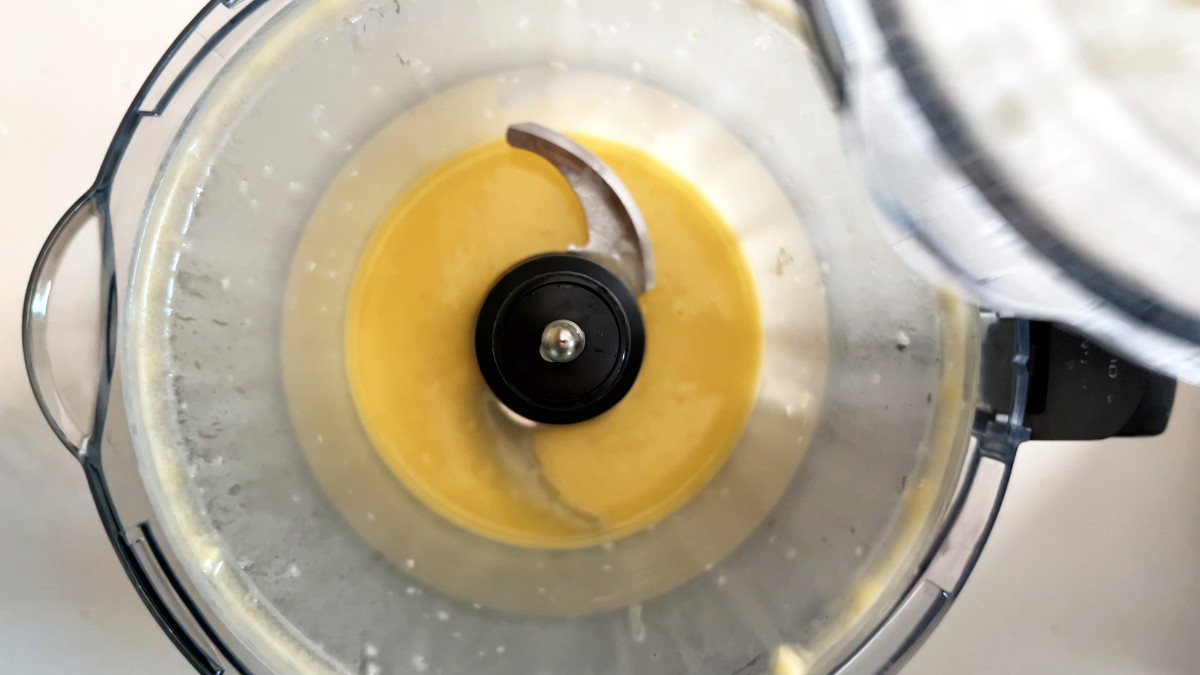 Yellow vinaigrette in a food processor.