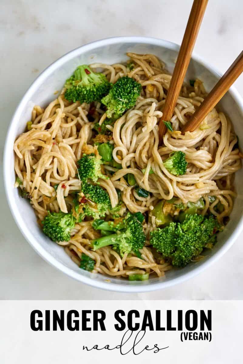 Bowl of noodles and broccoli with chopsticks.