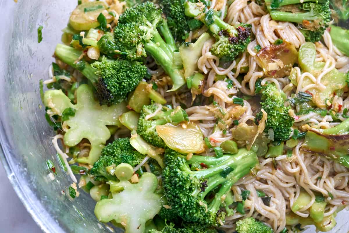 Noodles and broccoli in a glass bowl.