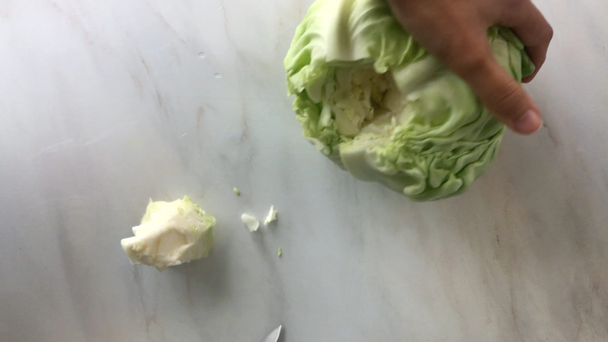 Core cut out of a green cabbage.