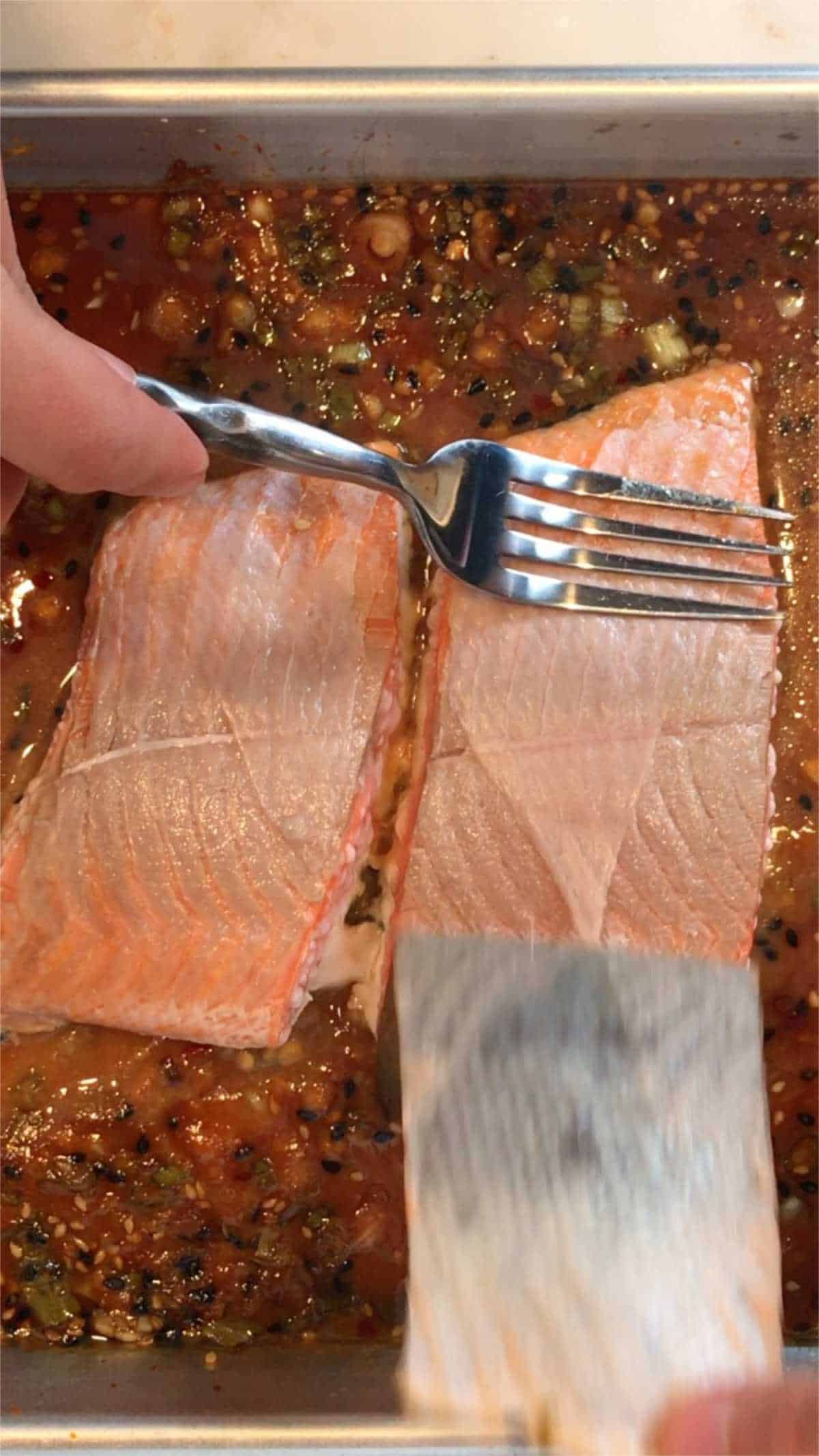 Peeling skin off salmon.