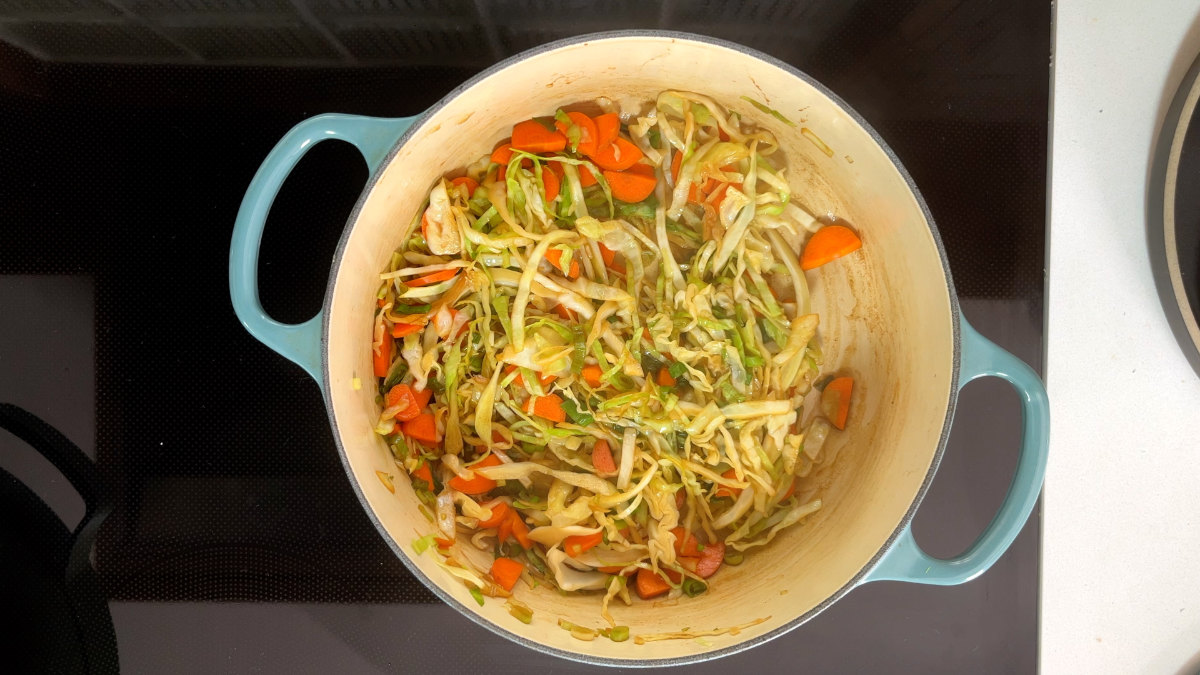 A pot of cooked cabbage and carrots.