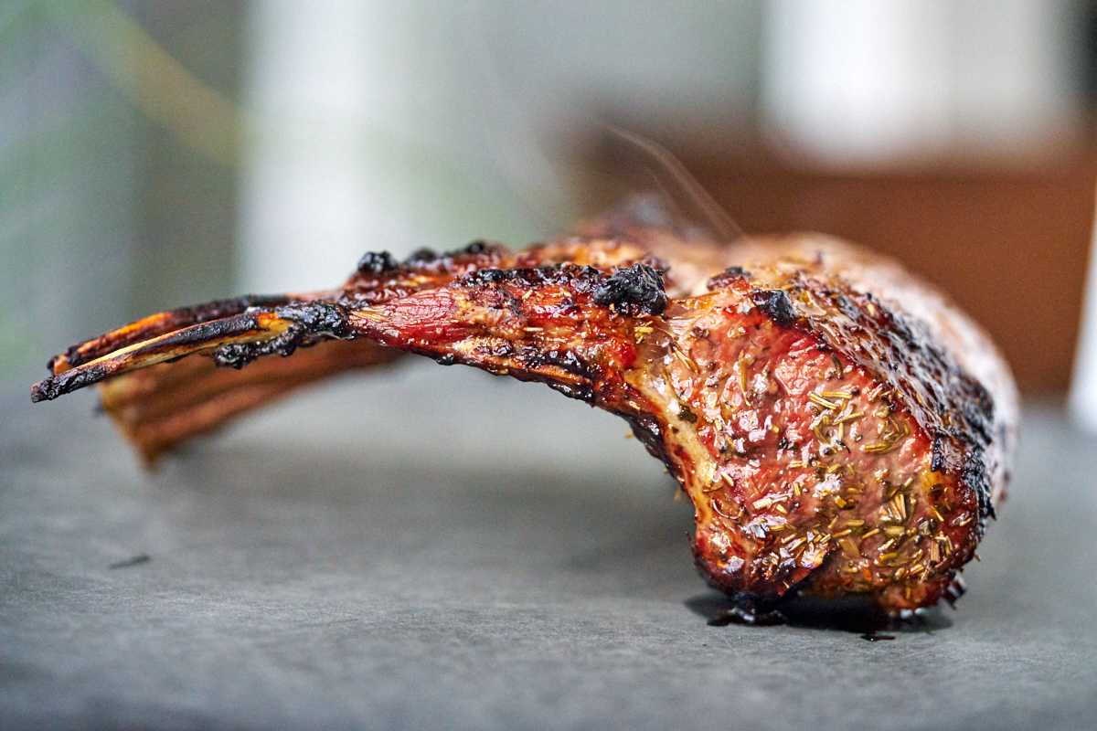 Cooked rack of lamb on a cutting board.