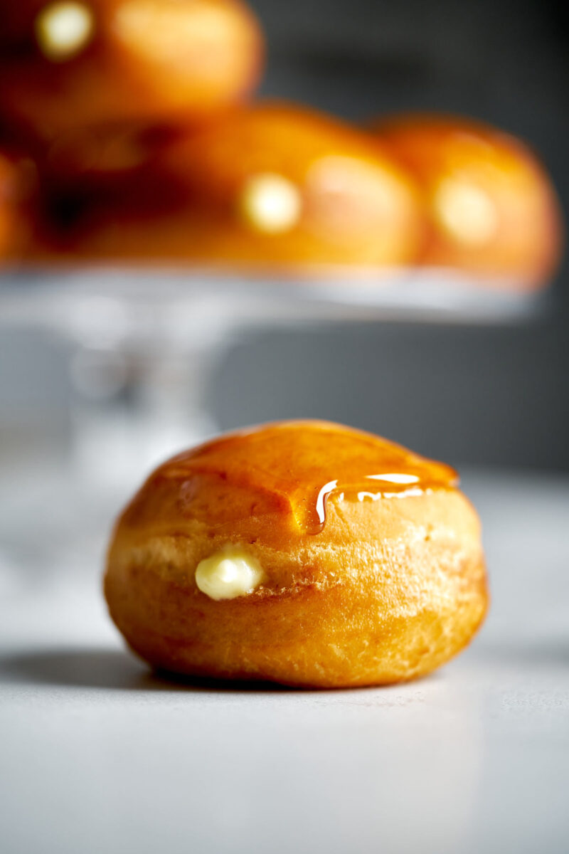 Filled donut topped with caramel.