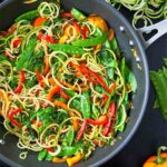 Stir fry surrounded by vegetables.