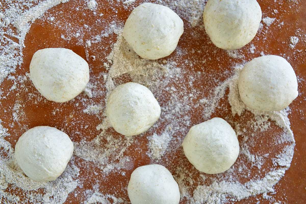 Dough balls on a cutting board.