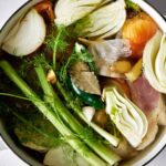 Raw vegetables in a stock pot.