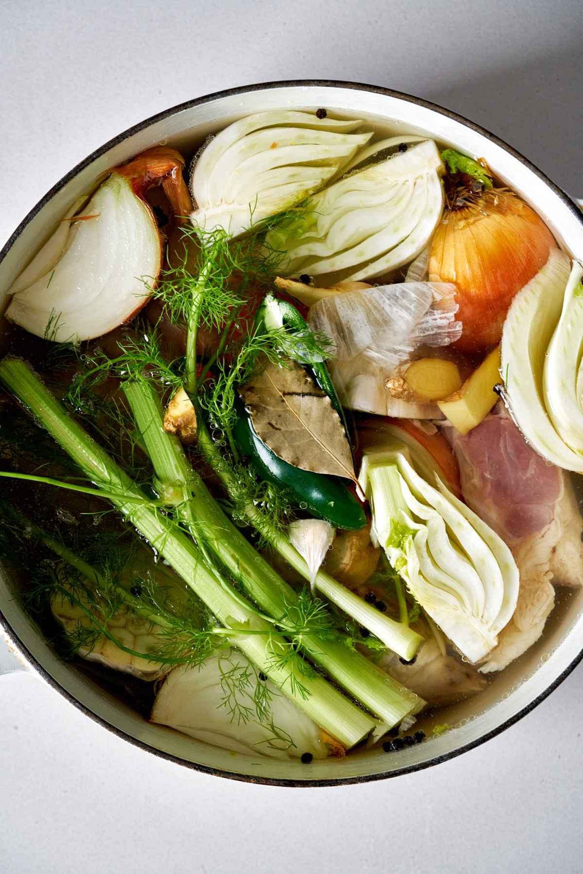 Raw vegetables in a stock pot.