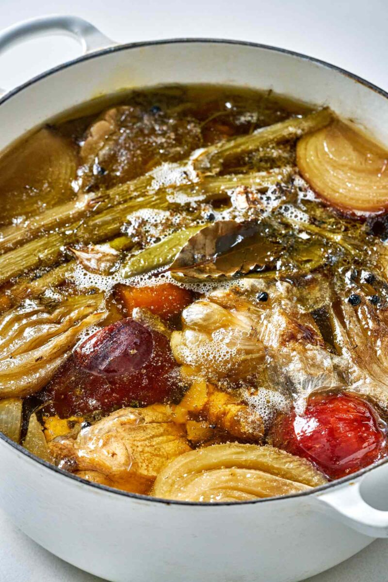 Side view of cooked stock in a stock pot.