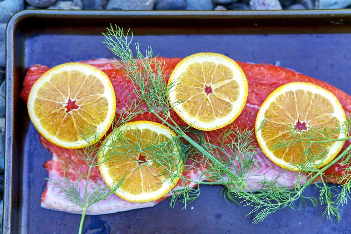 Salmon with herbs and orange slices.