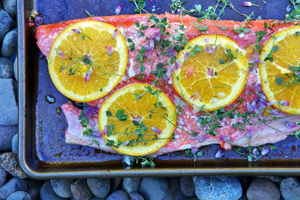 Salmon with citrus slices and herbs.