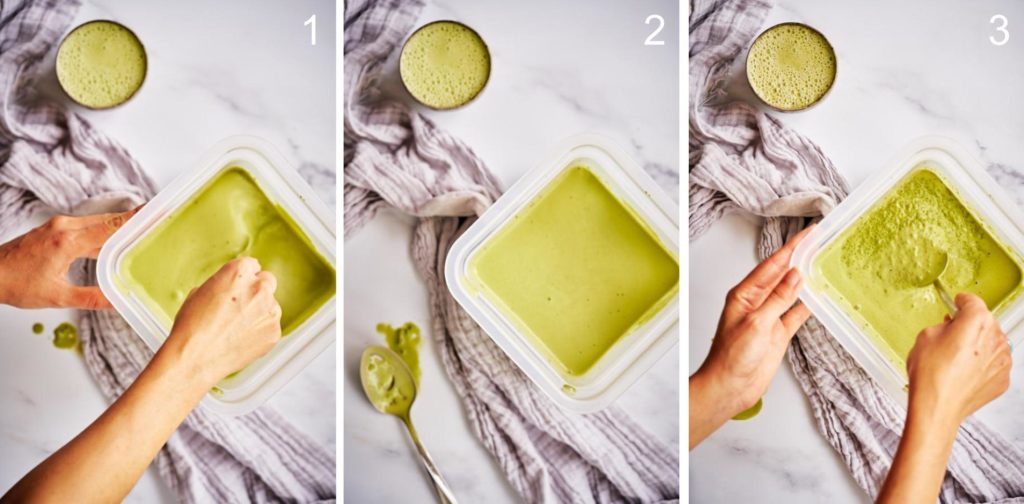 Stirring matcha chia pudding in a square container on a white marble counter with a matcha latte.