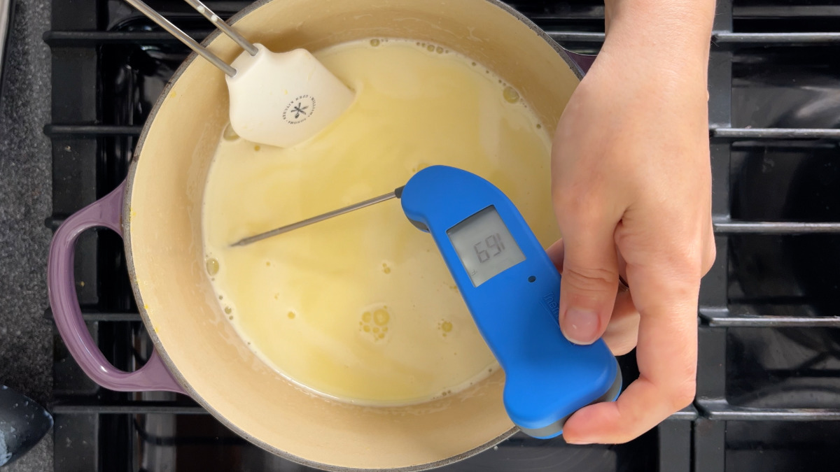 Blue thermometer checking ice cream temperature.