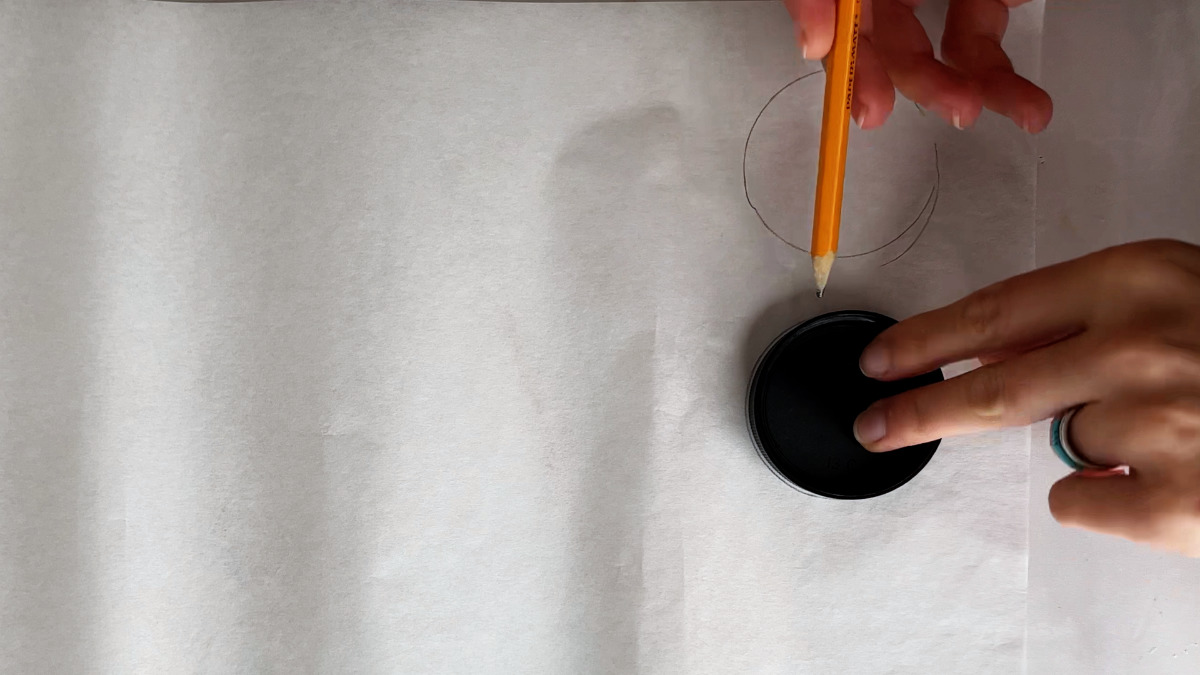 Drawing circles on parchment paper.