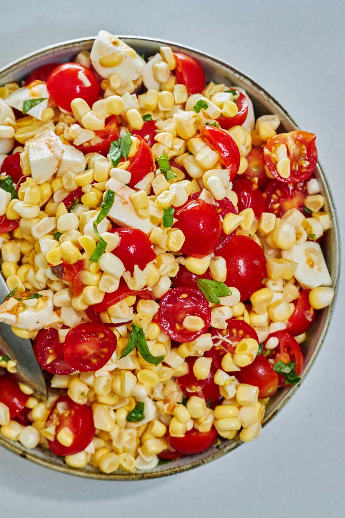 Corn and tomato salad in a large bowl.
