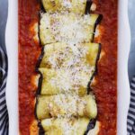Rolled eggplants in red pasta sauce.