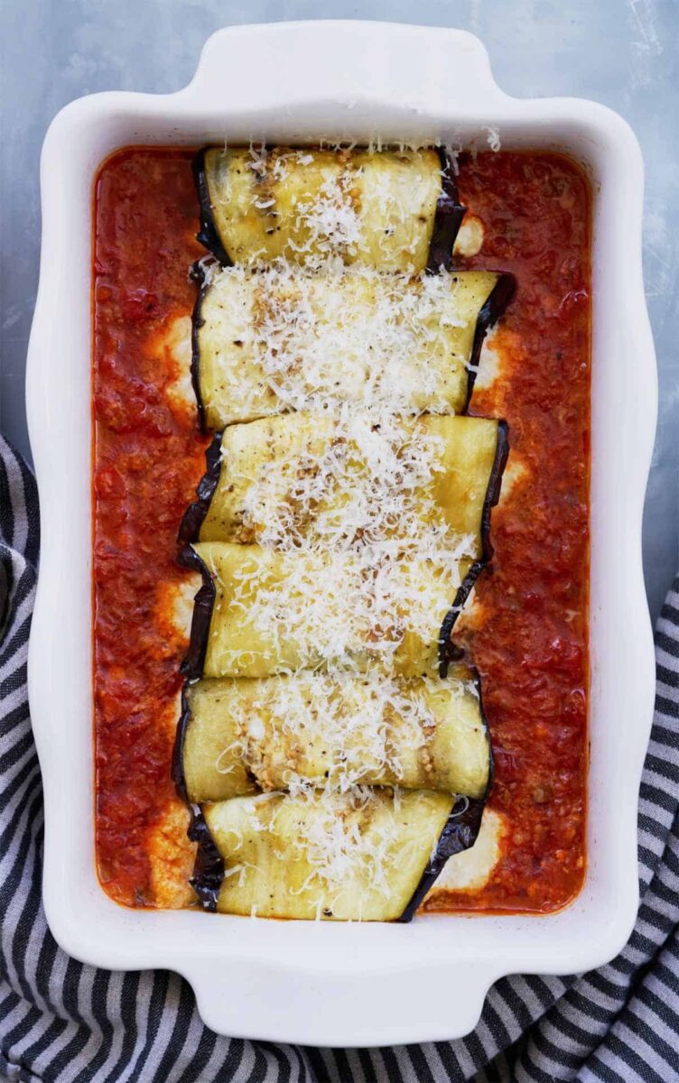 Rolled eggplants in red pasta sauce.