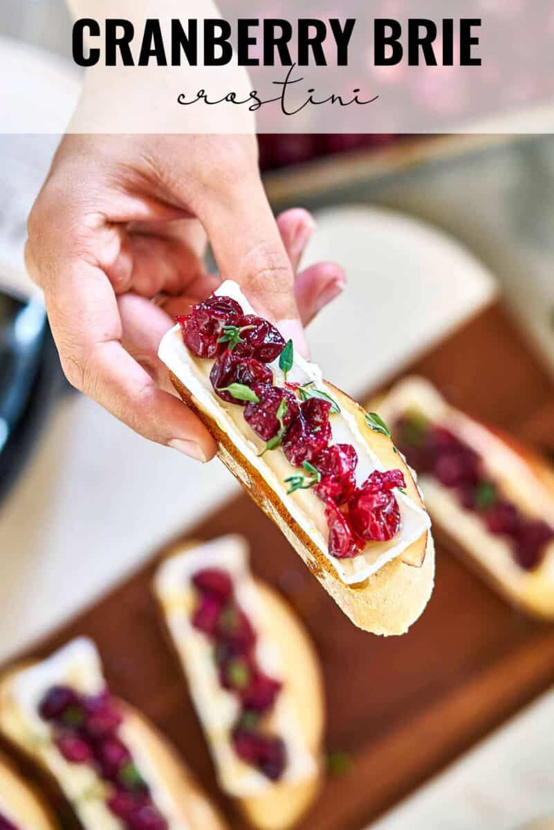 Hand holding a piece of crostini with title text.