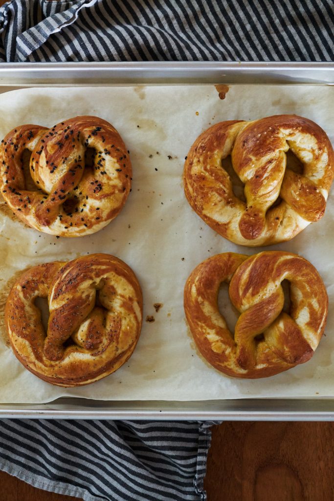 Cooked pretzels on a baking sheet.