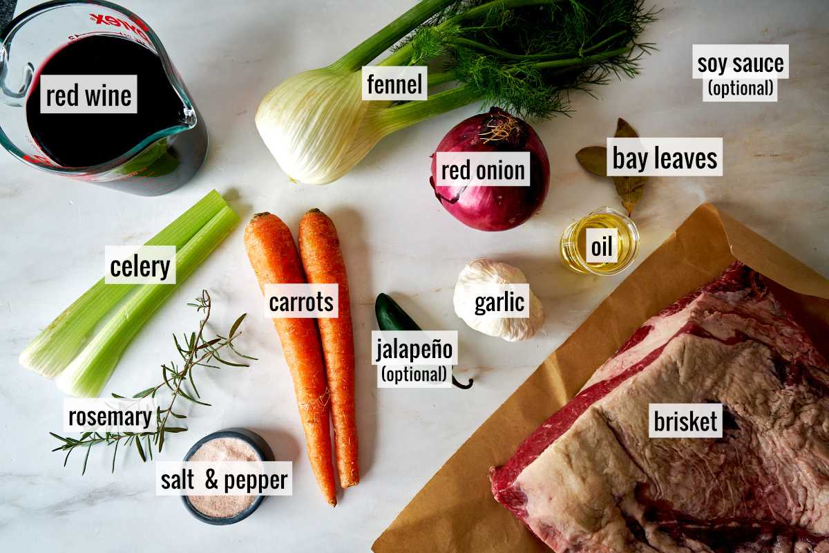 Brisket and other ingredients on a white countertop.