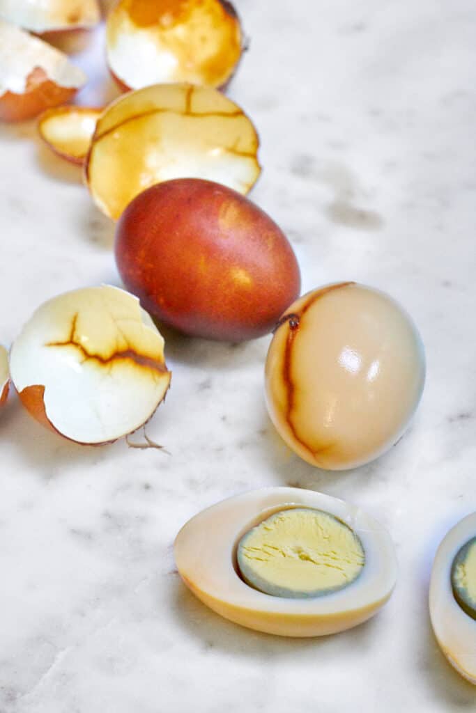 Tea stained hard boiled eggs with dark cracks and shells.