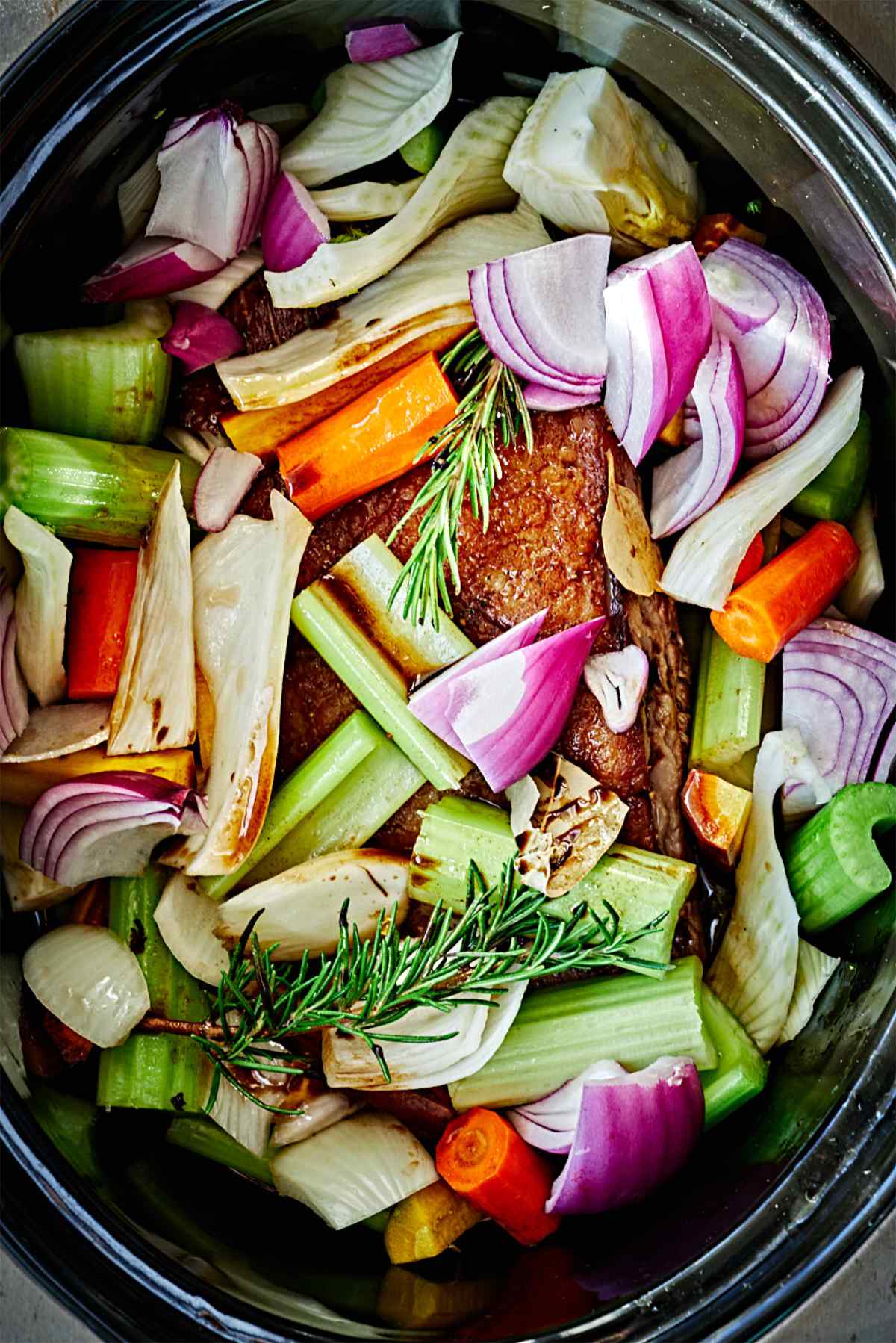 Meat and vegetables in a slow cooker.