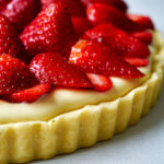 Fruit tart topped with strawberries.