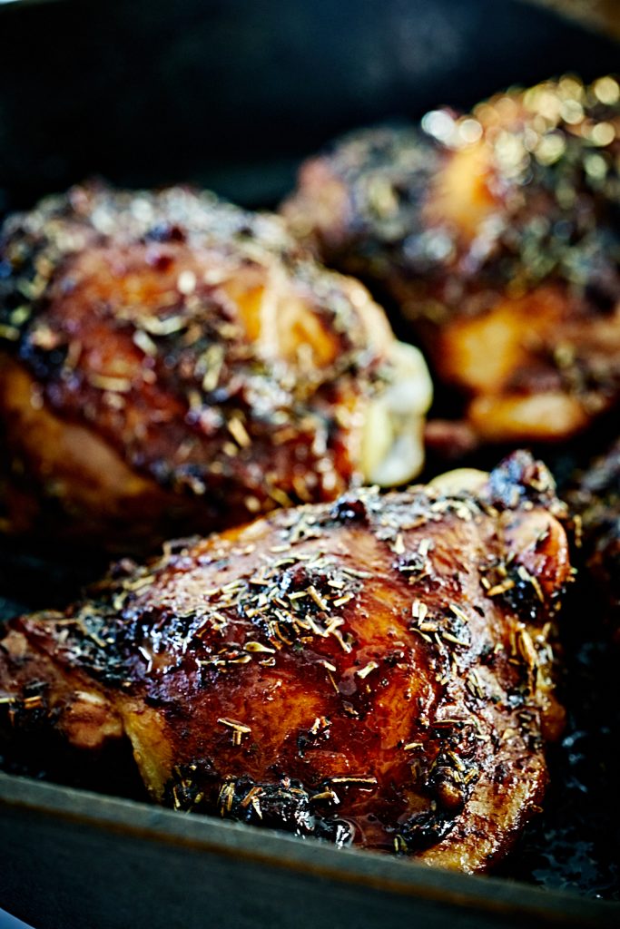 Cooked chicken thighs in a cast iron pan.