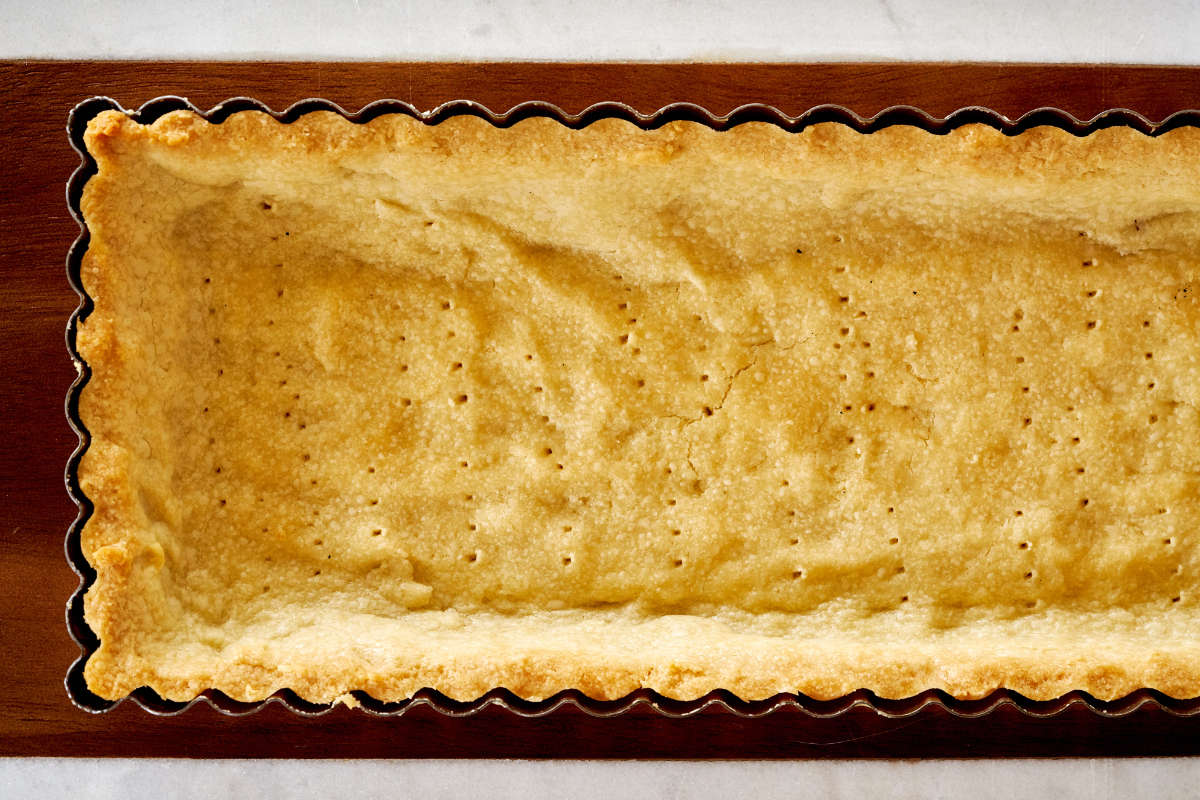 Baked rectangular tart shell.