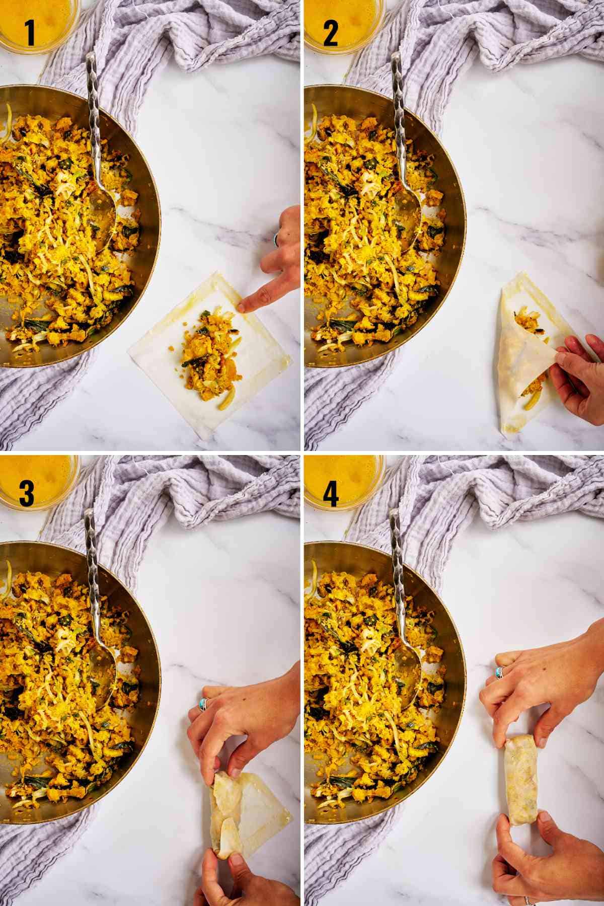 Rolling egg rolls on a countertop.