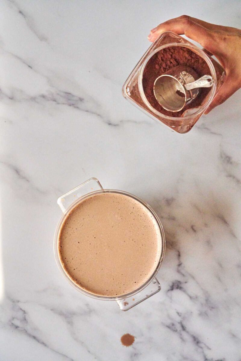 Nut milk next to cocoa powder.