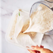 Pouring frothy milk into a bag.