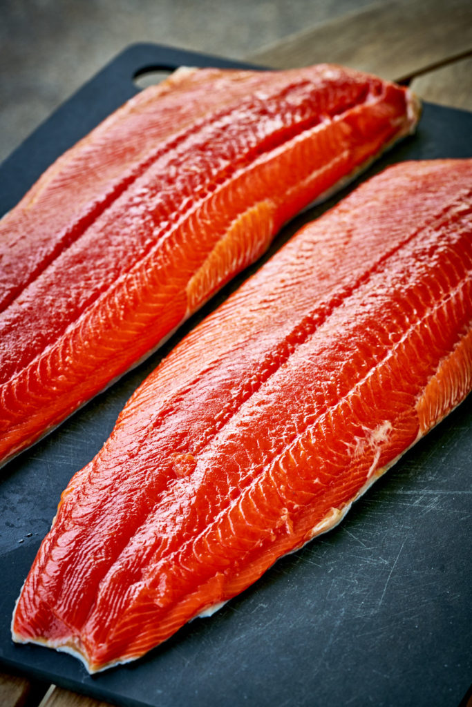 Deep red salmon on a cutting board.