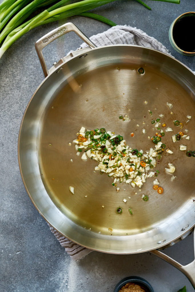 Fry pan cooking minced garlic.