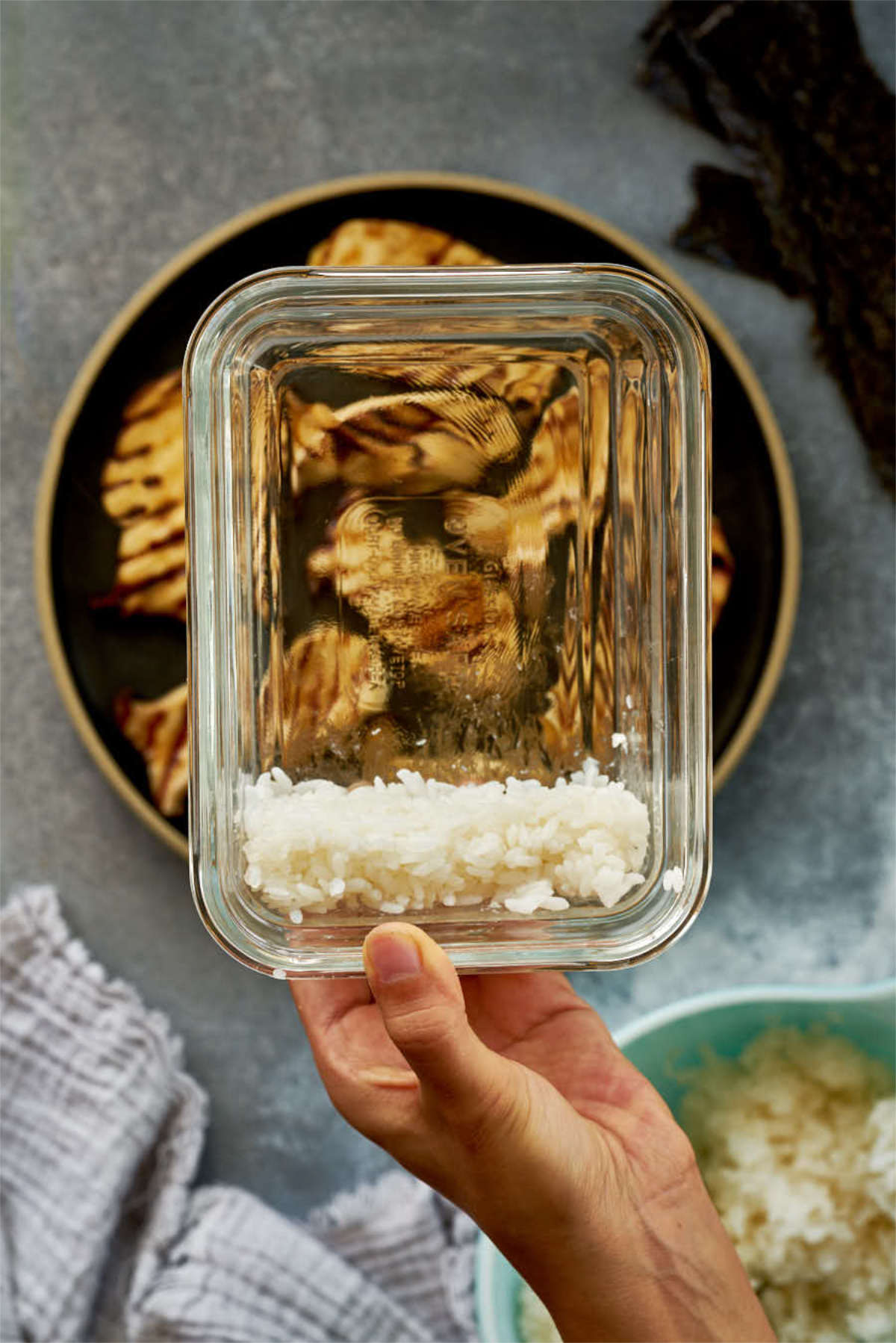 Rice on the side of a glass dish.