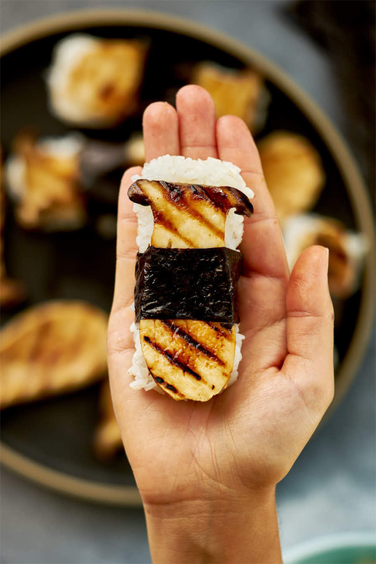 Mushroom sushi in a hand.