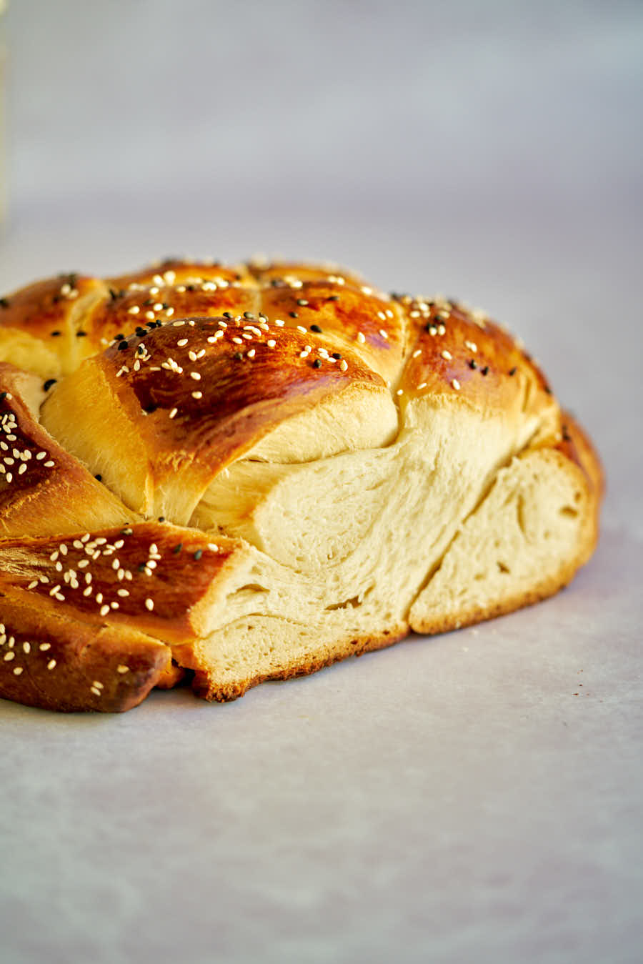 Loaf of sesame bread with slice cut out.