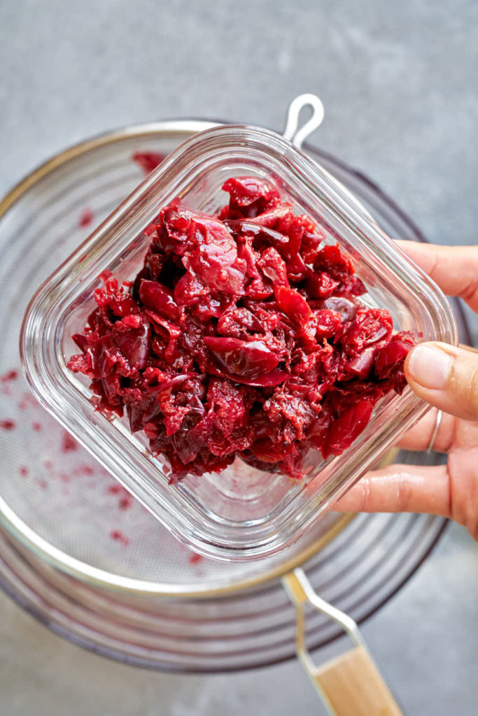 Cherry skins in square glass bowl.