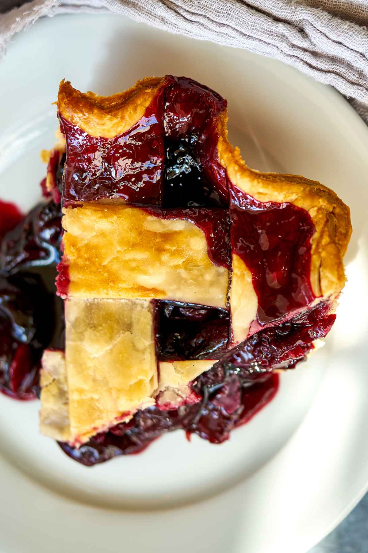 Top view of a slice of cherry pie.