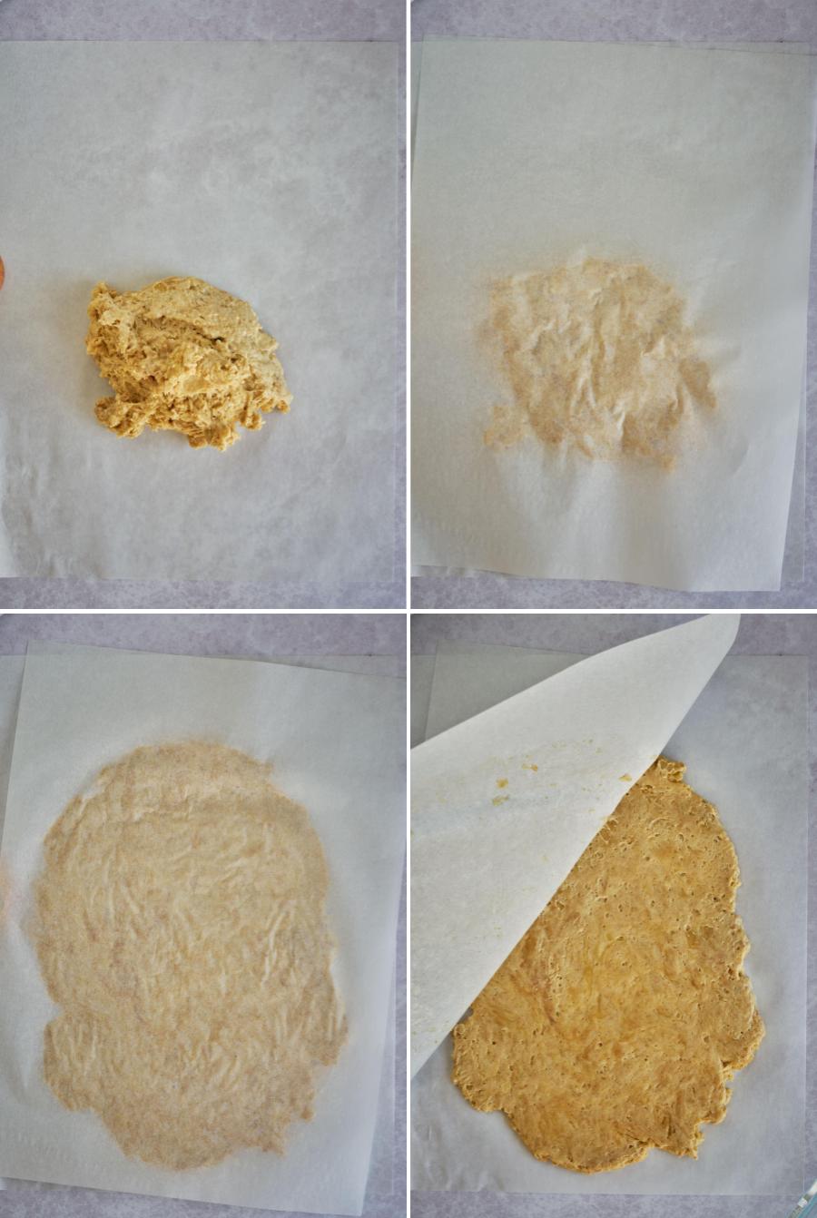 Rolling out dough between parchment paper.