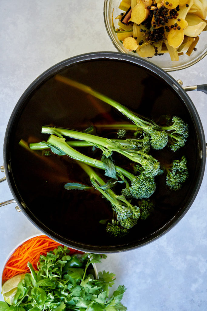 Pot of stock with broccolini.