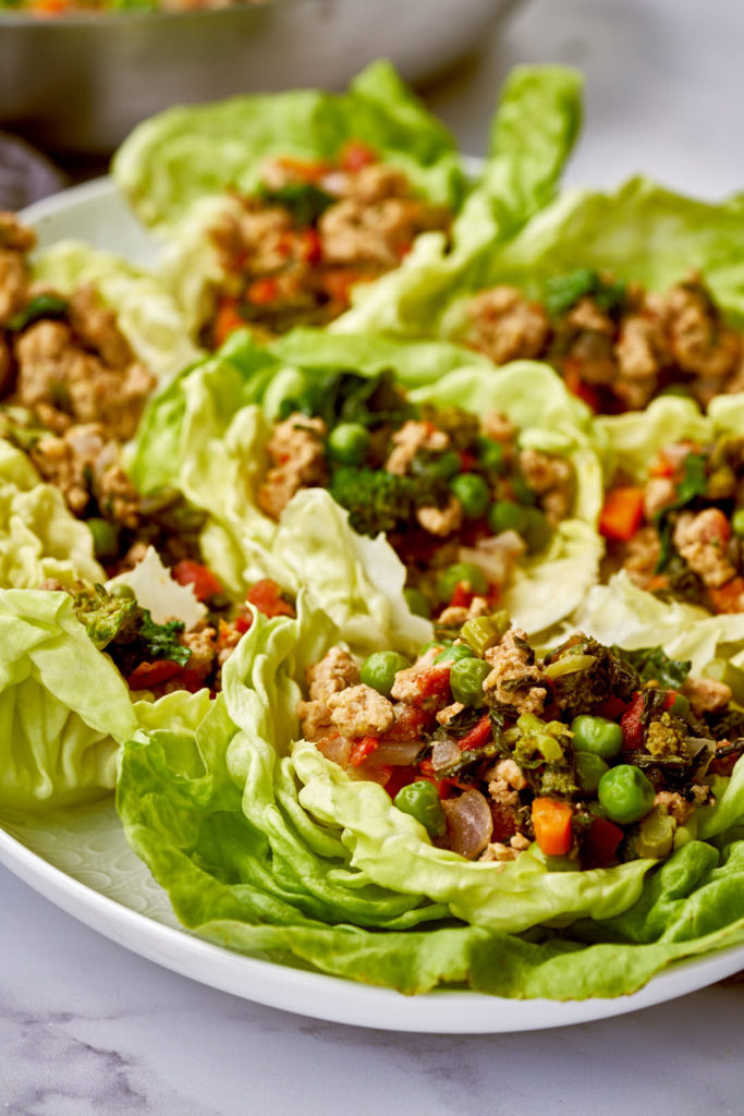 Turkey lettuce wraps on a white platter.