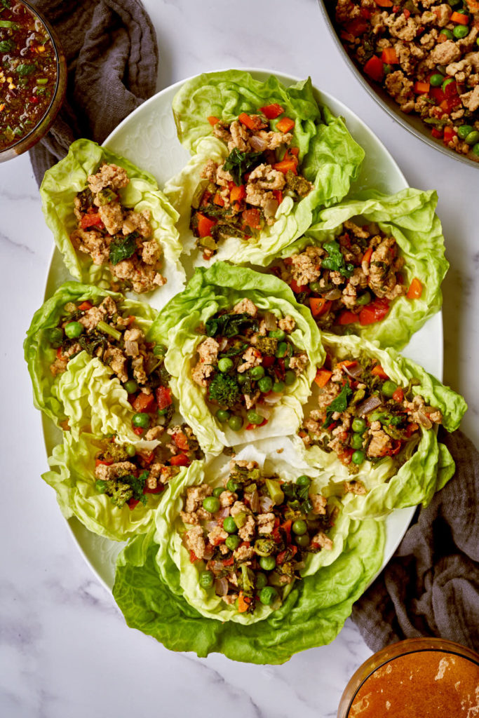 White plate filled with butter lettuce and lettuce cup filling