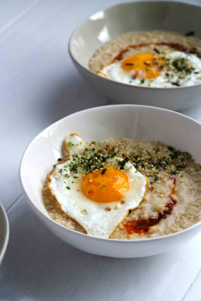 Bowl of oatmeal with fried egg.