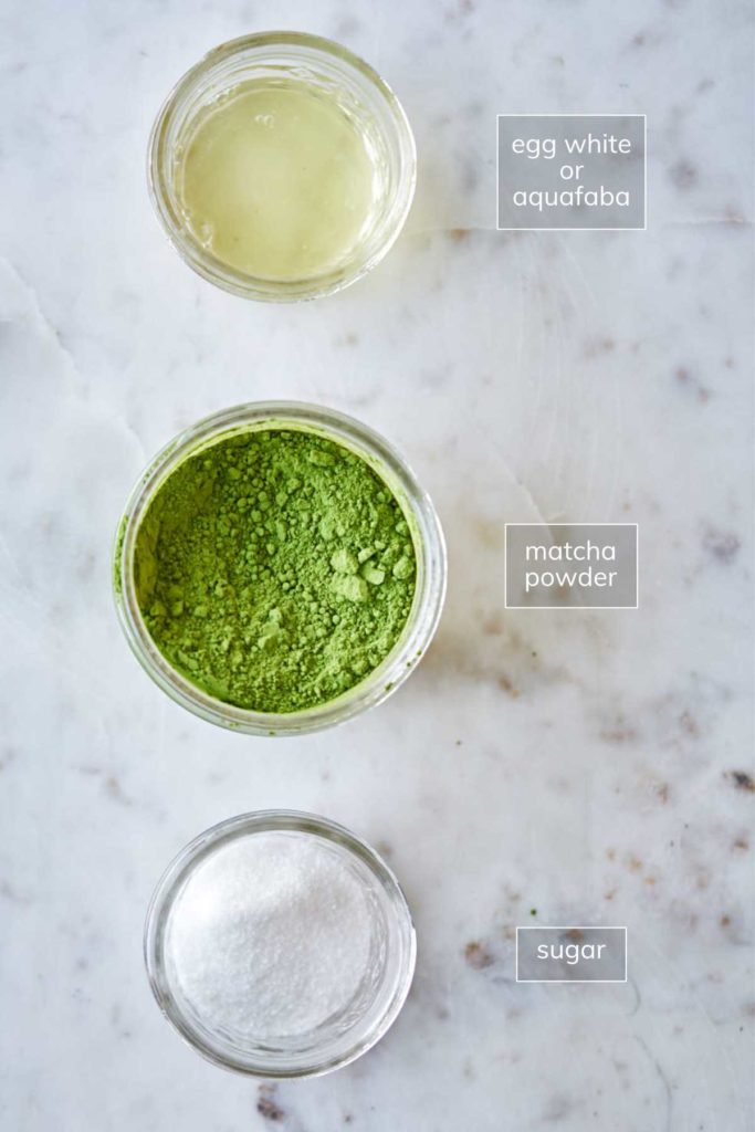 Egg whites, matcha, and sugar in small bowls.