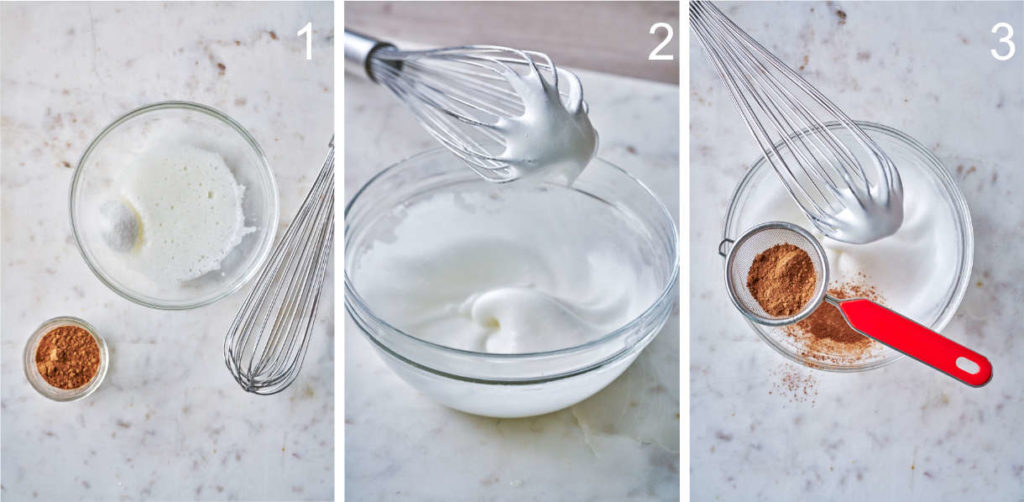 Whipping egg whites to soft peaks in clear bowl with whisk and chocolate.